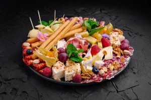 Exquisite charcuterie platter featuring a variety of cheeses, meats, fruits, and nuts