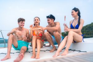friends relax fun with luxury party drinking champagne by talking together on catamaran yacht boat