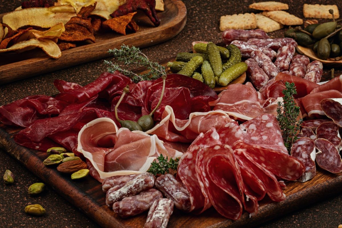 Appetizers table with differents antipasti, cheese, charcuterie, snacks and wine. Sausage, ham