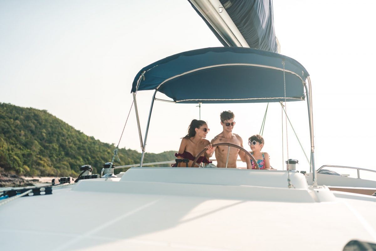 Caucasian couple relax fun with luxury party drinking champagne together while catamaran yacht boat