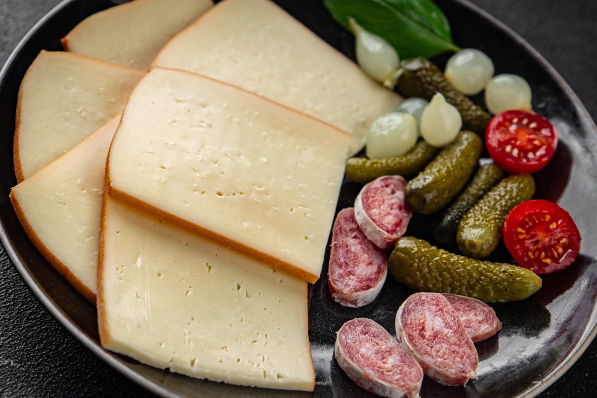 Raclette cheese food dish fresh gourmet tasty food background on the table rustic food top view copy