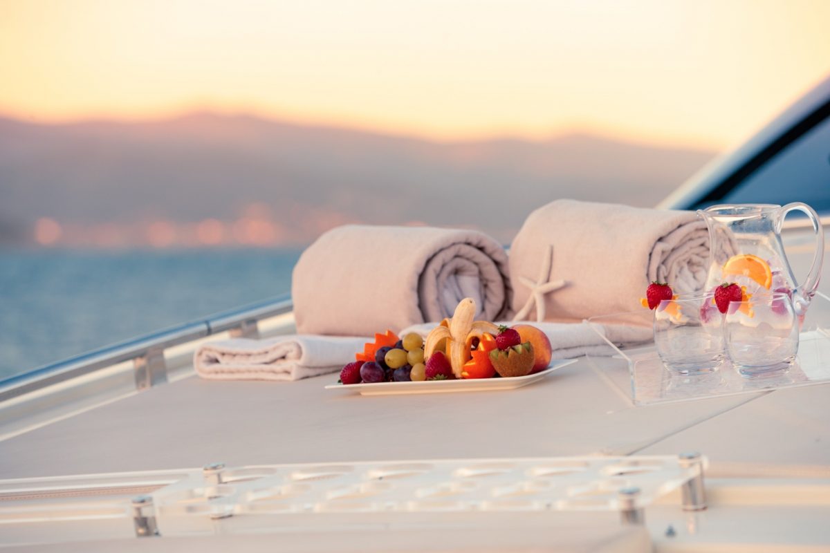 Selective focus shot of fruits on a white tray on the yacht