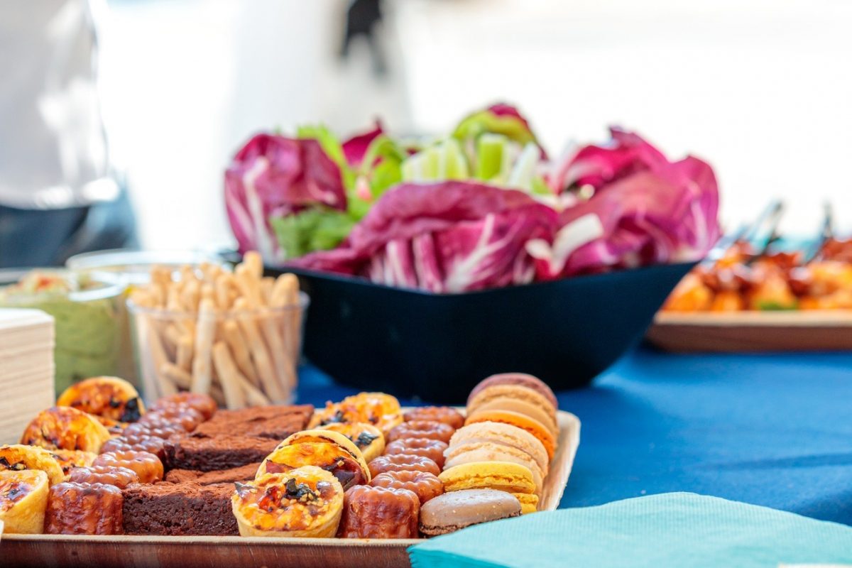 Vertical closeup shot of delicious desserts and appetizers on a table in a yacht