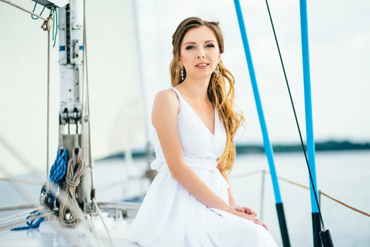 young girl on deck of sailing wooden yacht